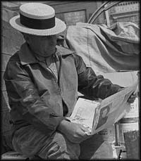 Photograph of honey peddler reading newspaper in market, San Antonio, Texas 1944