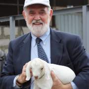 Image of Iraq mission director Tom Staal holding a lamb.