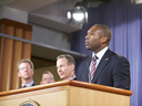 Acting Associate Attorney General Tony West delivers remarks while Housing and Urban Development Secretary Shaun Donovan, Assistant Attorney General for the Criminal Division Lanny Breuer, and New York Attorney General Eric Schneiderman look on.
