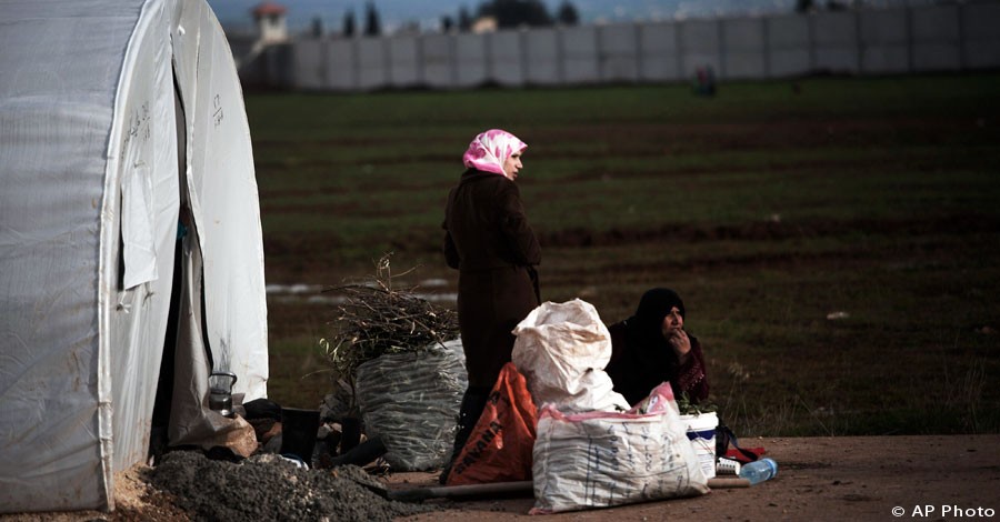 Displaced Syrian women are seen in front of their tent in the Azaz camp for displaced people, north of Aleppo province, Syria, Feb. 21, 2013. [AP Photo]