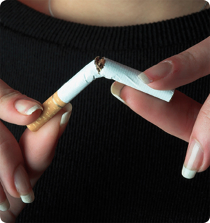 woman's hands snapping a cigarette in half