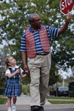 Man Walking Child Across Street