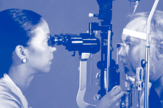 Ophthalmologist performing routine eye exam on a gentleman