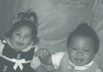 Photograph of two smiling babies.