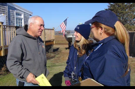 Homeowner Mike Gallagher, (L), receives information from FEMA Community Relations Specialists Angela Lynn, (C), and Maribel Rovira, (R). FEMA is working with state and local officials to assist residents who were affected by Hurricane Sandy. Location: 