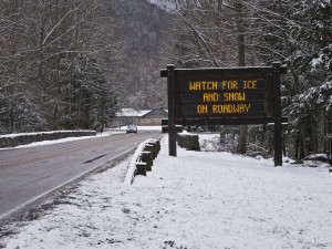 road sign warning of ice and snow