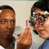 An eye care professional determines a patient's eyeglass prescription.