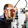 An eye care professional prepares for laser surgery for diabetic retinopathy (leaking blood vessels).