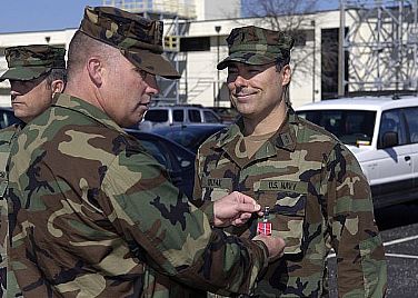 Capt. Frank Hughlett, commanding officer of Maritime Civil Affairs and Security Training (MCAST) Command, awards the Bronze Star medal to Lt. j.g. Ron Kolpak during an awards ceremony at Dam Neck Annex in Virginia Beach, Va. MCAST Command equips, trains and deploys maritime civil affairs and security force assistance teams to joint task force commanders to enhance partner-nation capability and capacity.  U.S. Navy photo by Mass Communication Specialist 2nd Class Matt Daniels (Released)  110311-N-8949D-004