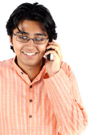 Photograph of a young man making a telephone call.