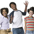 Photograph of three teens jumping for joy.