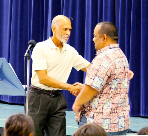 RMI Ambassador to the U.S., Charles Paul, right, shakes the hand of his former senior government teacher, Ric Fullerton, who still teaches at Kwajalein High School.