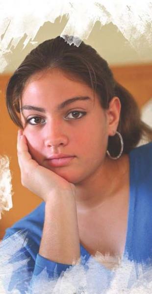 A young woman sits resting her chin in her hand.