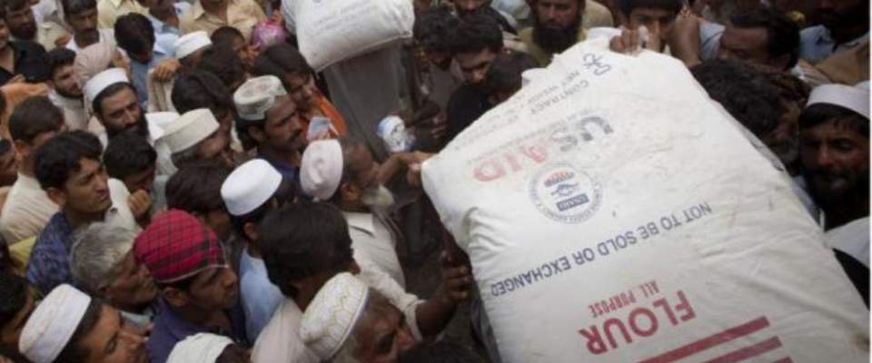 Pakistani men with USAID food assistance