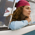 Photograph of a teen looking out the window of a van.
