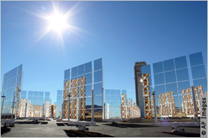 The sun shines above a field of mirrors that make up the U.S. National Solar Thermal Test Facility at Sandia National Laboratories in Albuquerque, New Mexico.