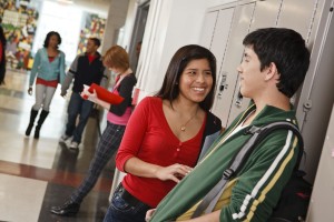 Teens talking in school hall