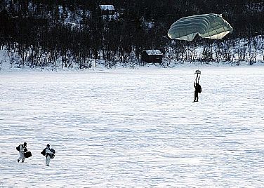U.S. Navy SEALs and German forces freefall parachute onto a frozen a lake in Northern Norway during Exercise Cold Response 2010. Cold Response is a Norwegian-sponsored multinational invitational exercise, with more than 9,000 military personnel from 14 countries focused on cold weather maritime and amphibious operations.  U.S. Navy photo by Mass Communication Specialist 2nd Class Matt Daniels (Released)  100223-N-8949D-130