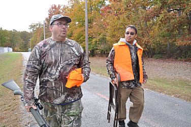 Navy firefighter Bill Robey (l.) escorts Sayngeun Phounamkha, an Army veteran and wounded warrior, to a ground blind on Naval Support Facility Indian Head's Stump Neck Annex during a deer hunt hosted in October by Naval Support Activity South Potomac.  121027-N-CE356-104