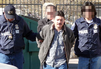 ICE officers escorting Miguel Angel Camacho-Aguilar
