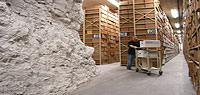 A staffer wheels a cart through the stacks of the Lenexa Federal Records Center