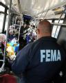 Local Residents wait on buses to visit the Disaster Recovery Center