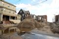 Piles of sand are formed outside of houses impacted by Hurricane Sandy