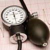 Manual blood pressure monitor on top of an EKG report