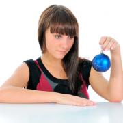 Teen girl looking at christmas ornament