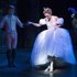 This theater image released by Sam Rudy Media Relations shows Laura Osnes as Cinderella, slipping on glass slippers designed by Stuart Weitzman, during a performance of "Rodgers + Hammerstein's Cinderella on Broadway."  Weitzman knows how to make shoes that make a splash. For years, he made the “million-dollar Oscar shoes,” diamond-covered footwear that a celebrity would wear to the Academy Awards. (AP Photo/Sam Rudy Media Relations, Carol Rosegg)