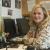 NIDA Communications Director, Carol Krause, sitting at her desk