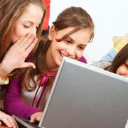 Teens talking in front of a computer