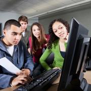 Teens looking at a computer
