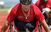 Photograph of diasabled veteran racing in a wheelchair