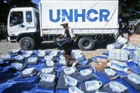Date: 10/01/1999 Location: Dili, East Timor Description: East Timor: Return of Internally Displaced Persons.  A UNHCR worker prepares repatriation kits which are distributed to returnees. The kits include plastic sheeting, a blanket, a gerrycan and soap.  © USUN Image