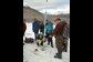 researcher and students measure glacier ablation stakes