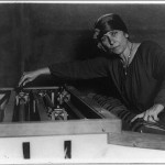 Mary Hallock Greenewalt, half-length portrait, at electric light "color organ", which she invented
