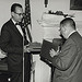 Photograph of Dr. James B. Rhoads Presenting Book of Tributes to Dr. Grover at His Retirement Party, 1965