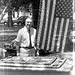 Sixth Archivist of the United States Robert Warner Standing in Front of the American Flag and the Cake While Celebrating the 50th Anniversary of the National Archives, 1984