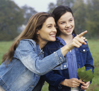 Photograph of a girl and her mentor observing the outdoors.