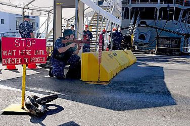 Sailors assigned to the submarine tender USS Emory S. Land (AS 39) cover the pier during an anti-terrorism force protection drill. Emory S. Land is on an extended deployment in Guam to temporarily relieve its sister tender USS Frank Cable (AS 40) as the primary afloat maintenance activity in the U.S. 7th Fleet area of responsibility.  U.S. Navy photo by Mass Communication Specialist 3rd Class Claire Farin (Released)  120126-N-ET019-654