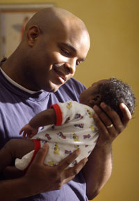 Photo: Father holding infant son