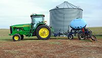 This tractor is towing an applicator, which allows fertilizers to be carefully placed on fields.