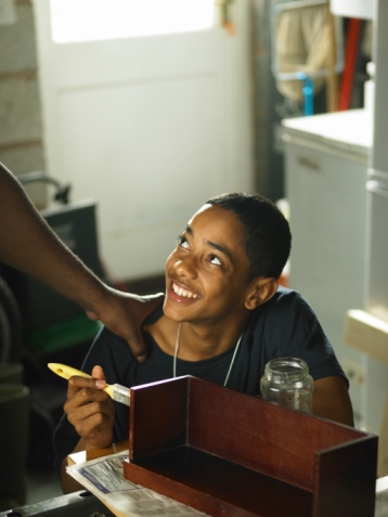 Photograph of a young person smiling up at an older mentor.