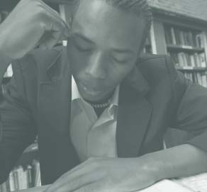 A young man studies in a library.