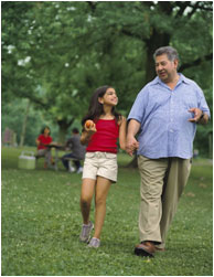 Man and child walking in the park