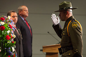 U.S. Border Patrol National Honor Guard Commander Carlos R. Ortiz salutes as a wreath is laid during the Valor Memorial Ceremony at the Ronald Reagan Building in Washington, D.C.