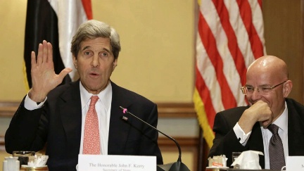 Date: 03/02/2013 Location: Cairo, Egypt Description: U.S. Secretary of State John Kerry, left, waves while ending a statement to the media, next to Mohammed Kassem, of World Trading Company, during a meeting with business leaders. © AP Image/Jacquelyn Martin