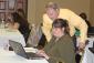 Image: Tom Simms assists Sandi Harkins during a computer training session