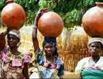 Women return home from the pump, carefully balancing clay jars full of water on their heads.  By Kelley Sams Kawari, Niger (1999).